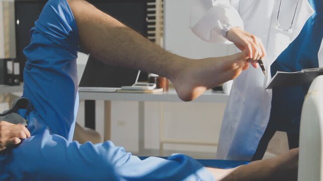 Physical therapist performing ankle examination on patient in clinic