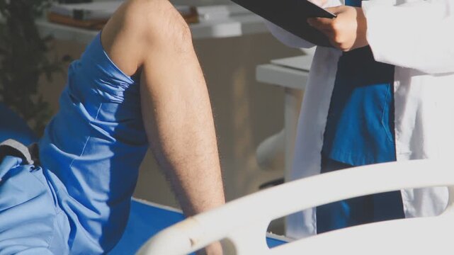 Physical therapist performing ankle examination on patient in clinic