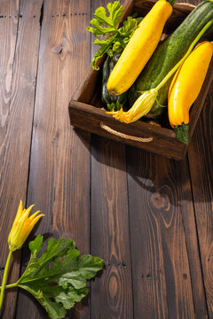 Fresh zucchini and squash harvest on rustic wood table