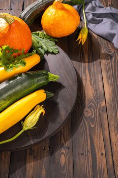 Freshly harvested organic squash and zucchini on wooden table