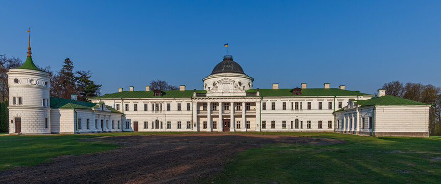 Beautiful wide panoramic view of an old antique classic palace mansion facade at sunset