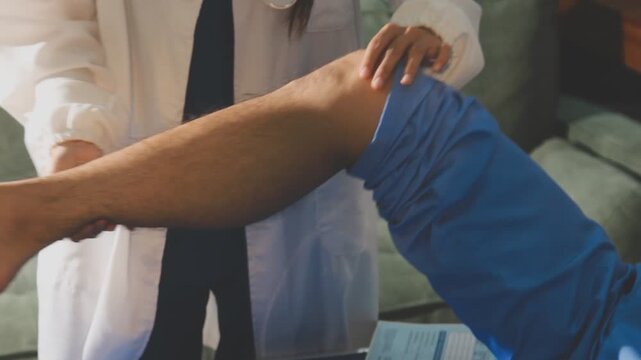 Physical therapist performing ankle examination on patient in clinic