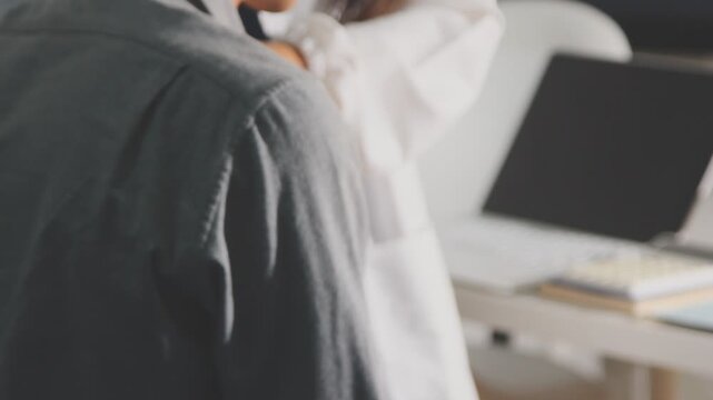Physical therapist performs shoulder range of motion test on male patient