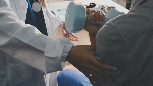 Physical therapist performs shoulder range of motion test on male patient