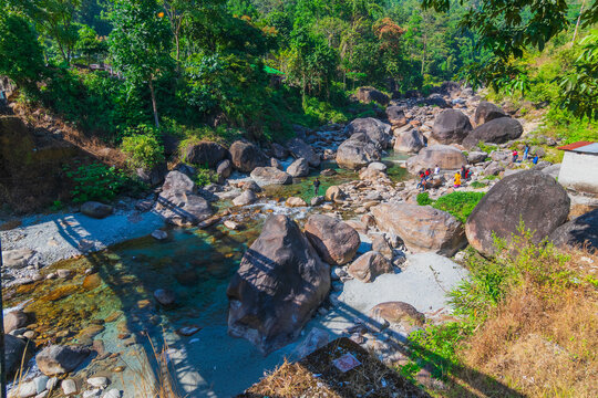 Beautiful view of Rocky islands, Jhalong sikkim. Daylight on green trees and a river filled with rcoks - nature stock image.