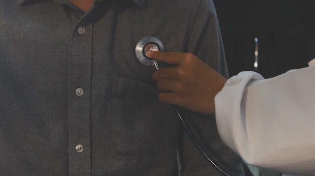 Doctor use stethoscope, checking up heart beat, auscultation in doctor office at hospital. Patient worker has to get medical checkup every year for her health or
