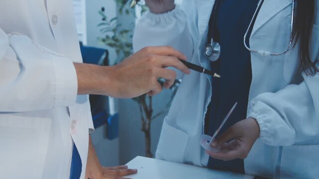 Doctor holding and pointing to an anatomical model of human lungs in a clinical office setting