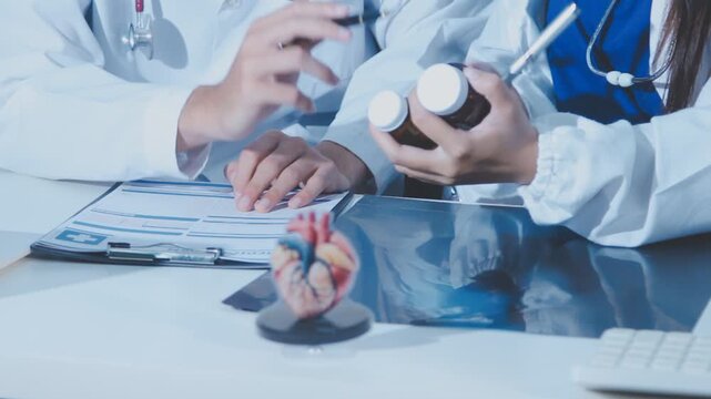 Doctor holding and pointing to an anatomical model of human lungs in a clinical office setting