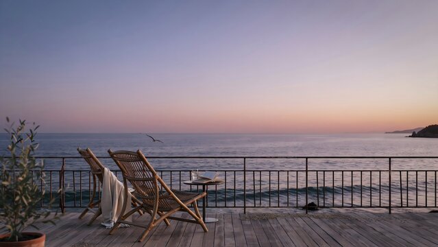 Scenic beachside evening with wooden chairs and railing overlooking ocean horizon