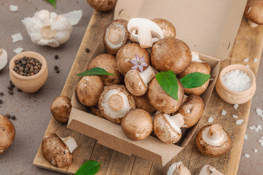 Fresh raw cremini mushrooms with spices and herbs. Healthy ingredient for cooking vegan food