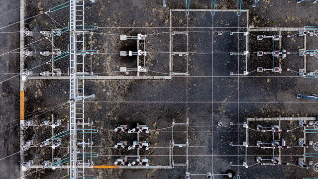 Aerial view of the Krokslon electrical power station with complex high-voltage wiring, metal infrastructure, and gravel ground in Iceland.
