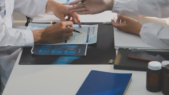 Doctor holding and pointing to an anatomical model of human lungs in a clinical office setting
