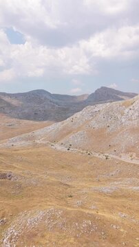 Drone Aerial View Flying Across Arid Mountain Peaks and Dry Valley Landscape on Visocica