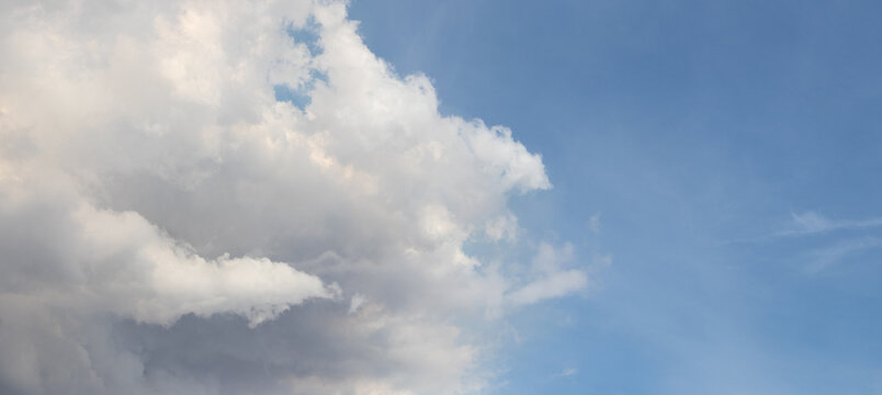 Large white cloud against blue sky with copy space