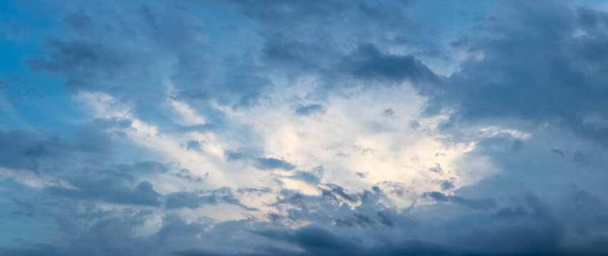Dramatic sky with dark clouds and glimpse of light