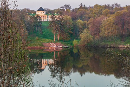 Beautiful scenic landscape of an old historic palace mansion on a hill with lake reflection