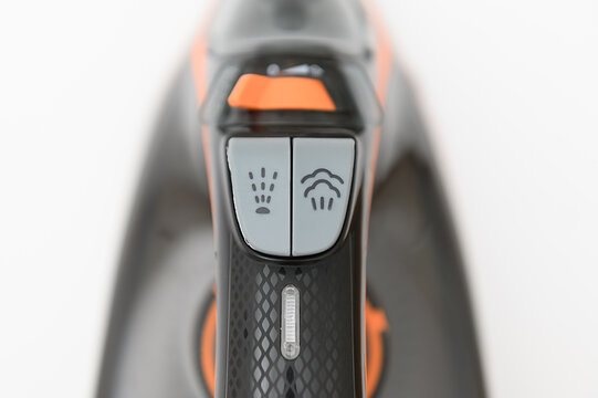 Special markings on the iron. On a white background. The iron is black with orange accents.