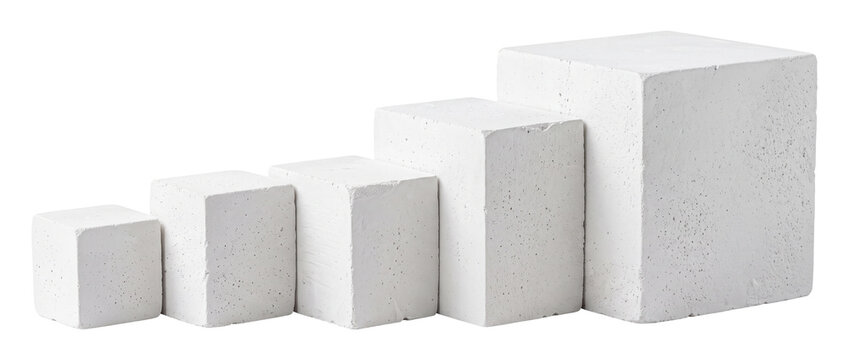 White concrete cubes growing ascending in size chart on black background representing business development, step by step success, financial scale, minimal progress concept and modern geometric art.