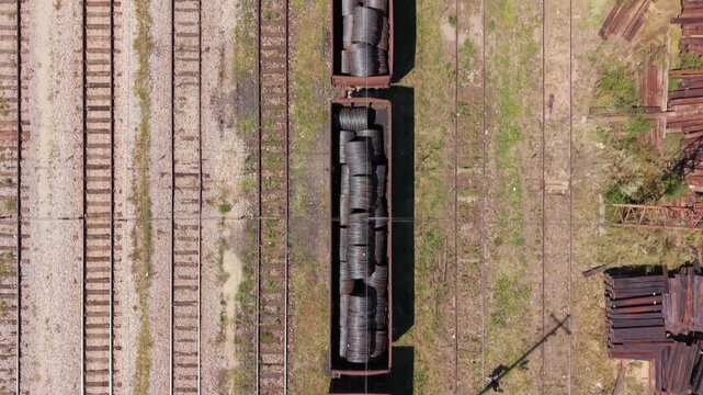 Drone Aerial View Flying Nadir (Top-Down) Over Freight Train Wagons Loaded with Steel Wire Coils at Podlugovi Railway Station
