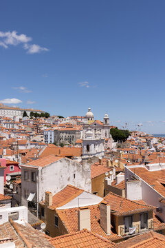 landscape shot of Lisbon rooftops on a sunny day with blue skies