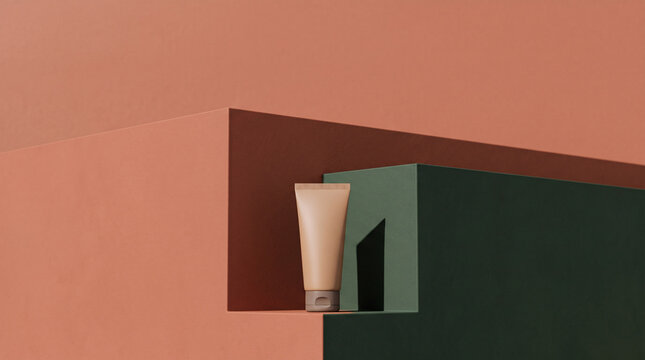 Blank cosmetic tube mockup placed on a modern geometric background with earthy tones.