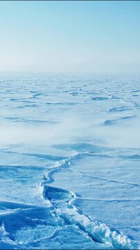Massive arctic ice sheet shifting across vast frozen plains during dramatic motion climate change.