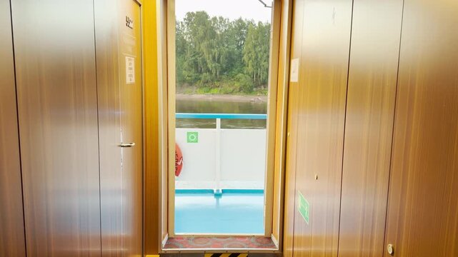 A cruise ship sails calmly. A scenic river flows past. Peaceful feelings emerge.