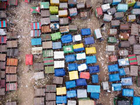 Aerial view of the Van Stand with numerous colorful rickshaw vans parked in a dense grid in Narayanganj, Dhaka, Bangladesh.