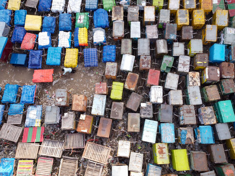 Aerial view of a dense van stand filled with numerous colorful rickshaws and carts parked in rows in Narayanganj, Dhaka, Bangladesh.