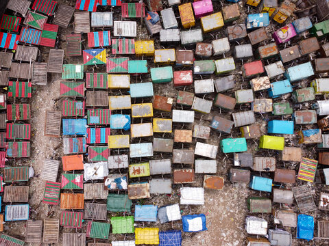 Aerial view of the Van Stand in Narayanganj, Dhaka, Bangladesh, featuring a dense grid of colorful, weathered rickshaw vans parked closely together.