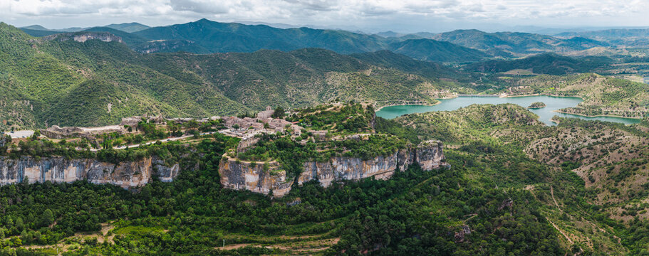 Aerial view of Siurana village perched on dramatic sandstone cliffs above Siurana Reservoir in Catalonia, Spain
