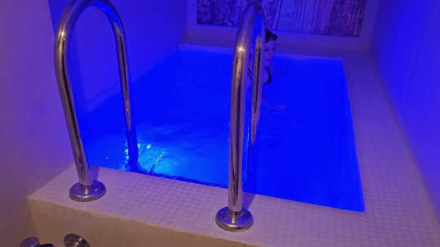 Experience a unique activity in a small blue-lit pool at a spa location