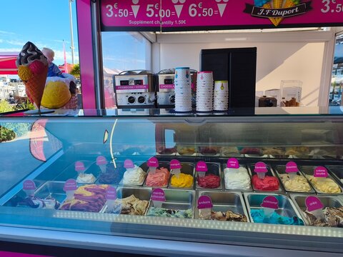 Royan, France - May 31, 2026: Charente-Maritime. Nouvelle-Aquitaine. Colorful ice cream display in glass case at J.F. Dupont shop with various flavors and cones visible