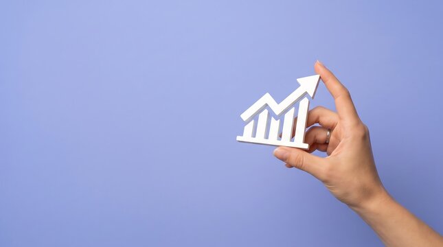 Hand holding white graph with upward arrow on blue background