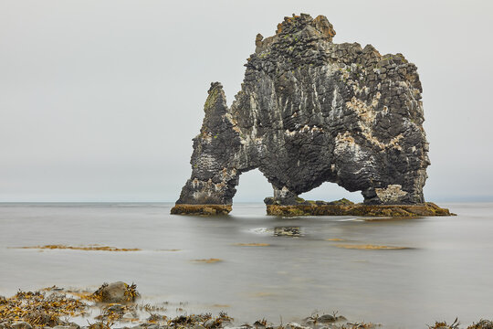 Hvitserkur sea stack standing in still water off the Vatnsnes coast