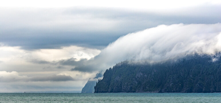 Rolling clouds surrounding island in Resurrection Bay, Kenai Fjords 