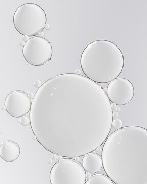 Cosmetic serum with transparent bubbles macro skincare texture on white background