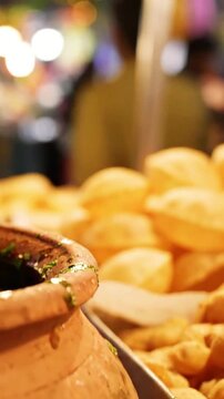 Traditional panipuri snack display featuring delicious fried dough balls in this vibrant street food.