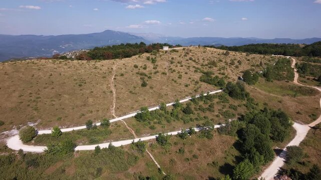 Drone Aerial View Flying Over Winding White Gravel Paths and Dry Hill Plateau at Javorov Do Bjelasnica