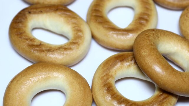 a table with a bunch of bagels sitting on top. Rotating in a circle