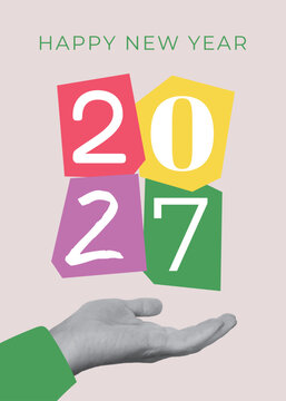 Happy New Year 2027 greeting card in pop art collage style. Human hand holding paper cutouts with year numbers on gray background.