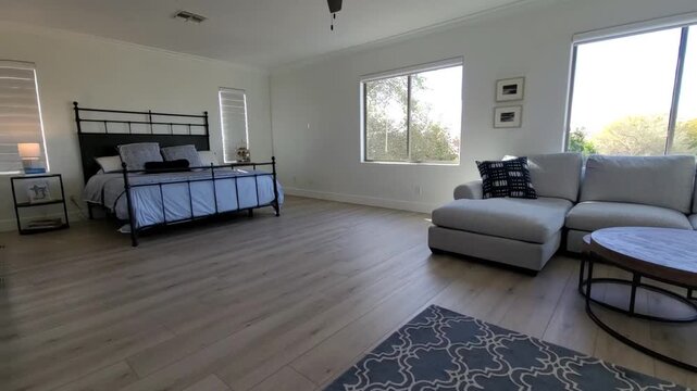Bright daylight bedroom with metal bed and large windows