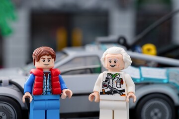 Naklejka premium Tambov, Russian Federation - July 30, 2026 Lego Marty McFly and Doc Brown minifigures standing in front of the DeLorean time machine car from Back to the Future.