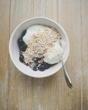 A bowl with fresh blueberries oats and yoghurt matte