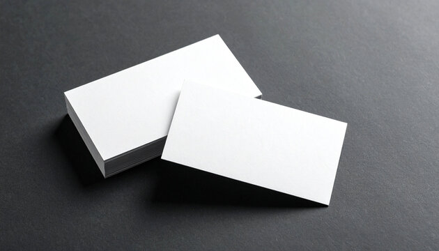 Minimalist blank white business card stack mockup on textured black background, copy space.