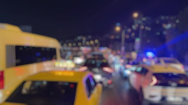 A blurry video showing a major traffic jam on Altinyol Street in Izmir after a midnight accident, with flashing police lights and drivers standing outside their vehicles in frustration.