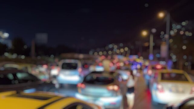 A blurry video showing a major traffic jam on Altinyol Street in Izmir after a midnight accident, with flashing police lights and drivers standing outside their vehicles in frustration.