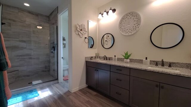 Contemporary bathroom vanity with round mirrors and warm lighting
