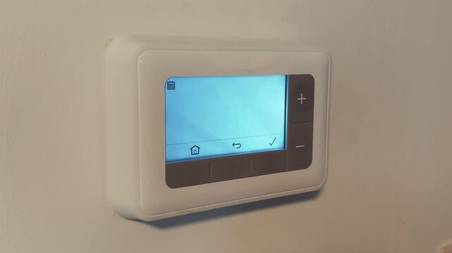 Setting the digital thermostat temperature in a house with clear display readings