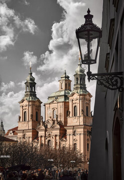 Prague, Czech Republic. Saint Nicholas Cathedral at central Old Town square Sraromestska. Evening sunset street landscape with lantern.